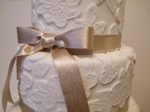 White and gold lace design wedding cake
