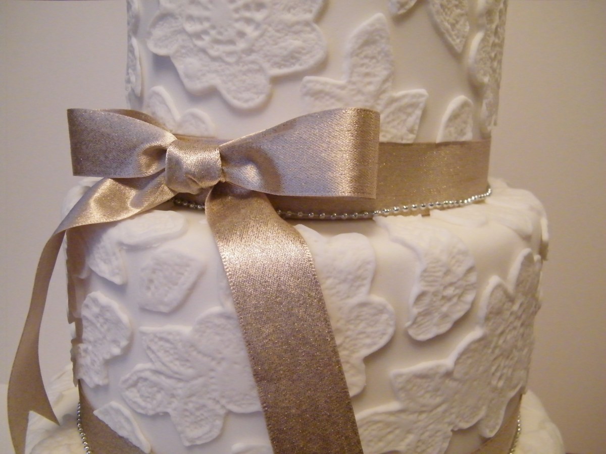 White and gold lace design wedding cake