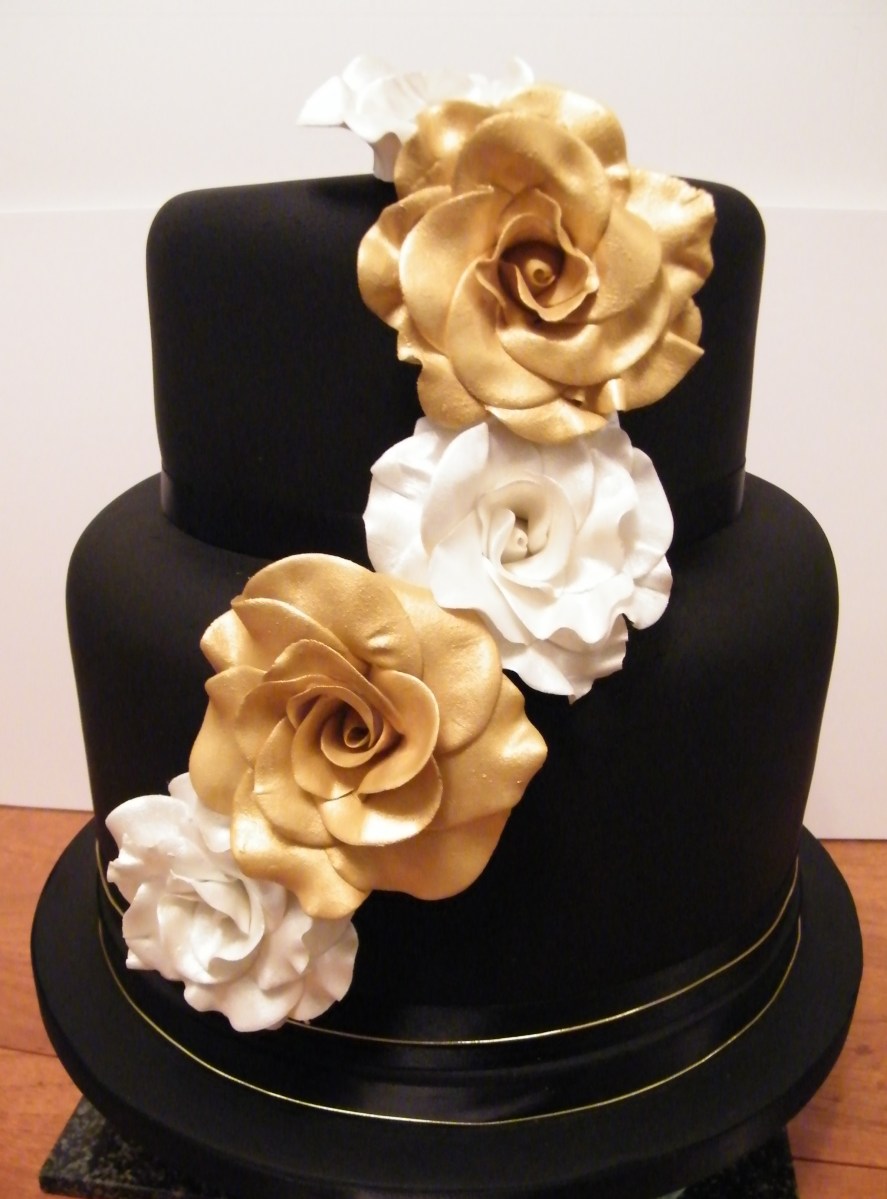 Black wedding cake with handmade gold and silver sugar roses