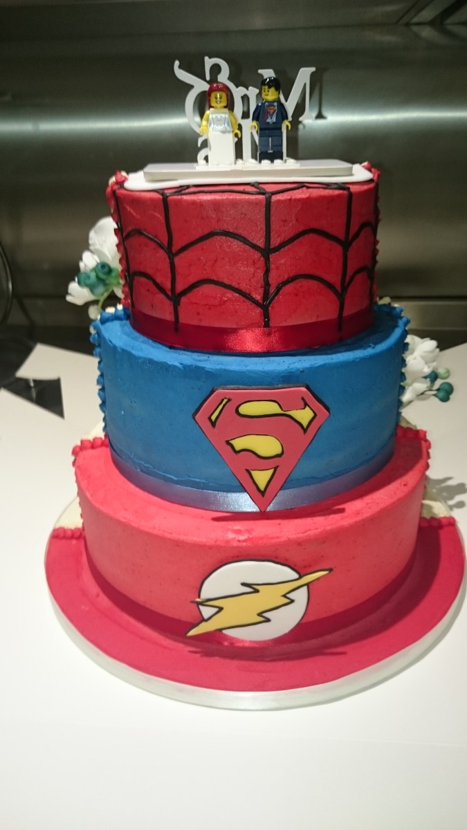 Semi-naked half and half wedding cake with handmade sugar flowers and superhero design