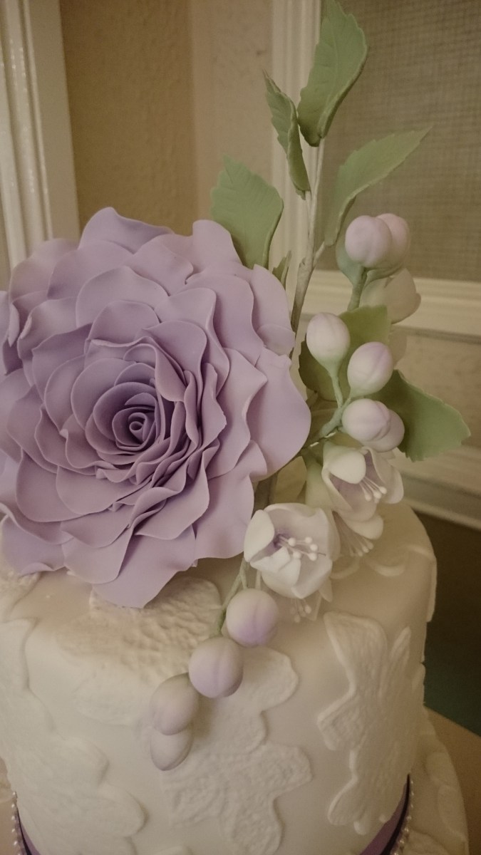 Lace design wedding cake with handmade sugar flowers