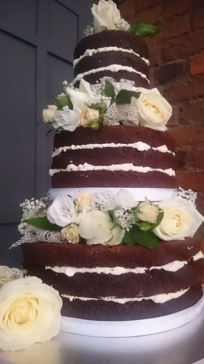 Naked chocolate 3 tier wedding cake with fresh flowers