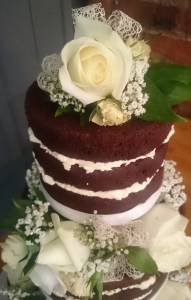 Naked chocolate wedding cake with fresh flowers